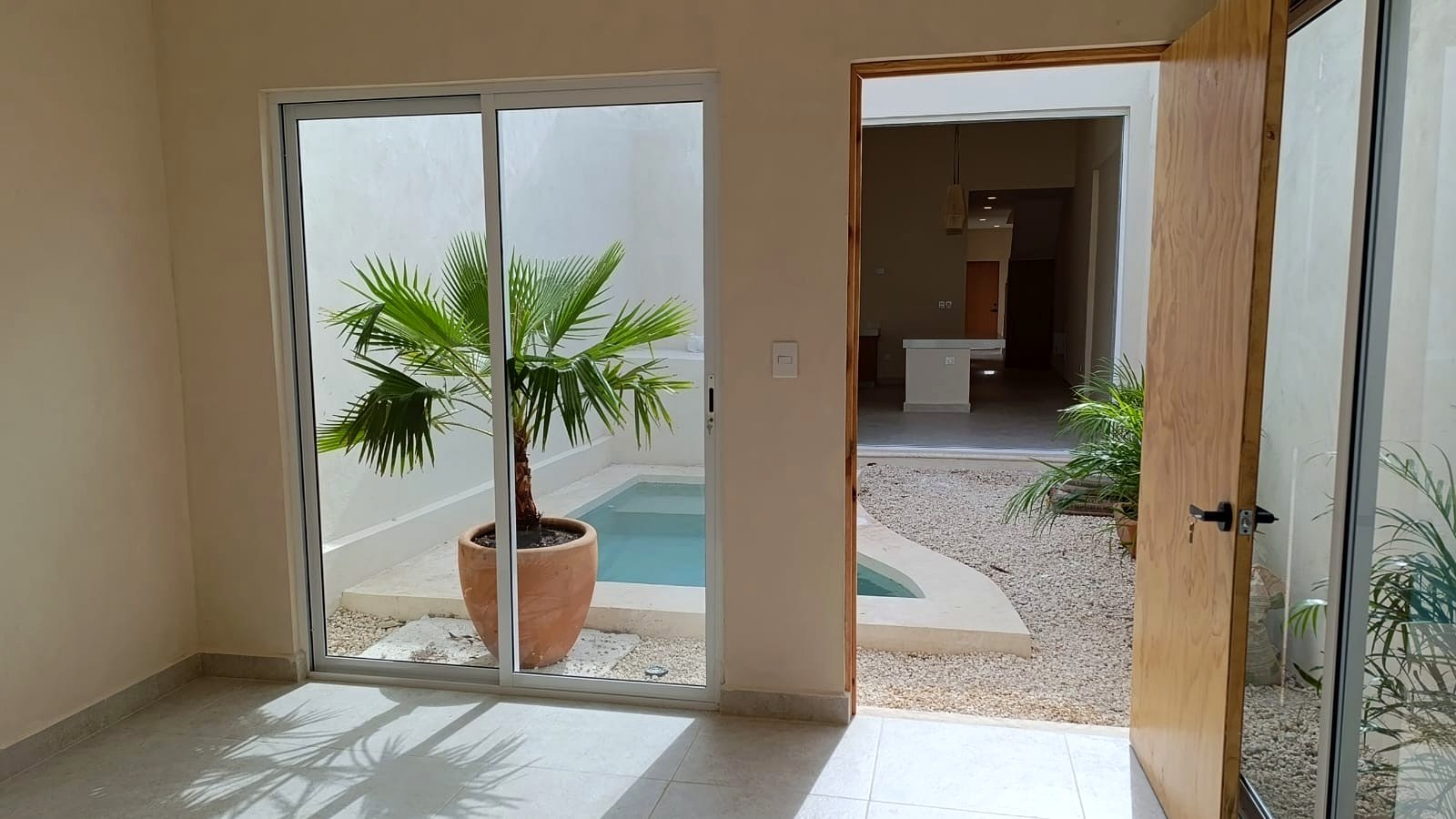 Casa Suspiro — courtyard overview with pool, lounging area, and entrance