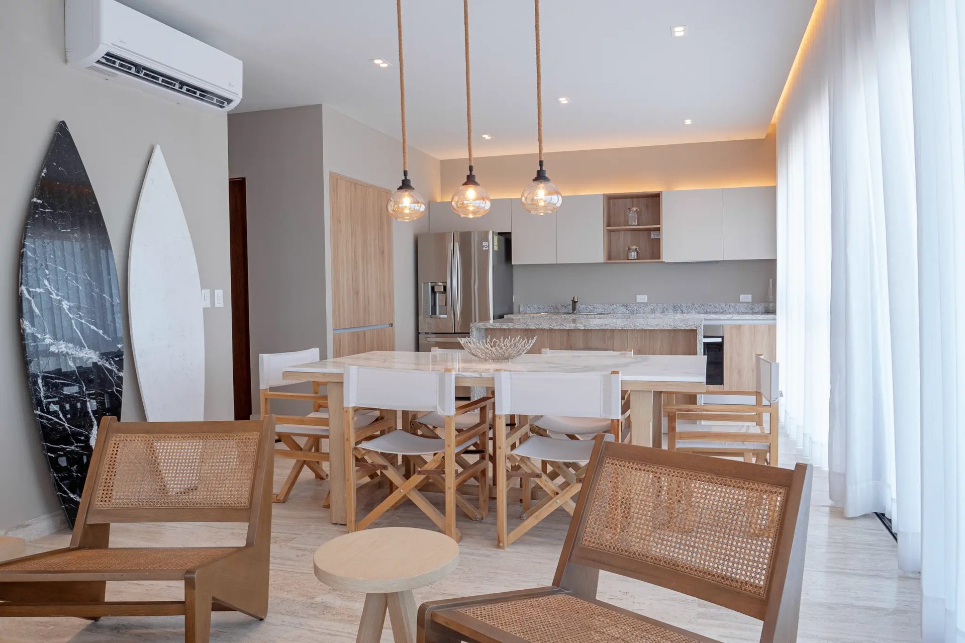 Bonanza B-707 — open-concept living and dining area with coastal décor