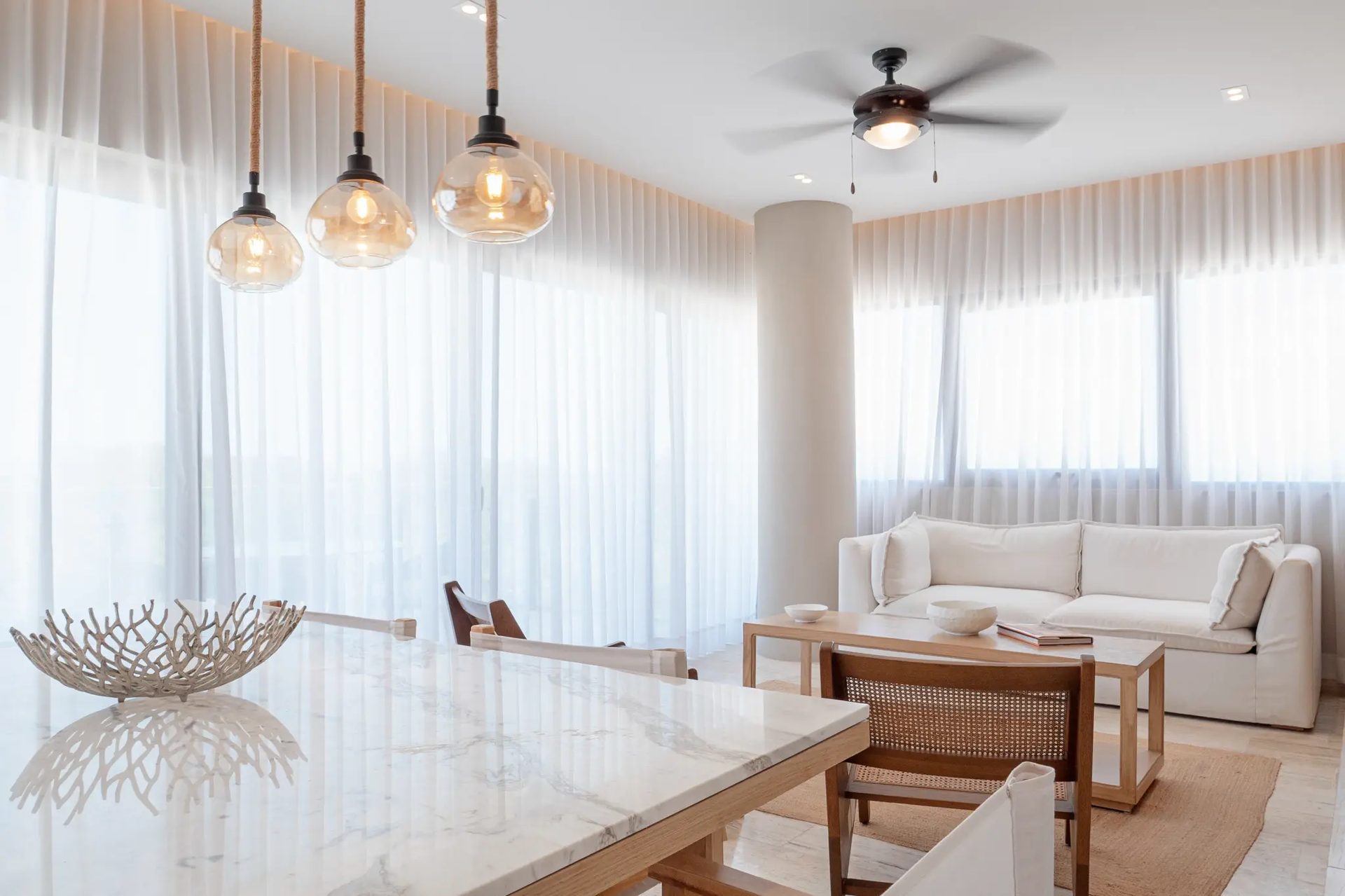 Bonanza B-707 — living room with marble counter, pendant lights, and ocean light