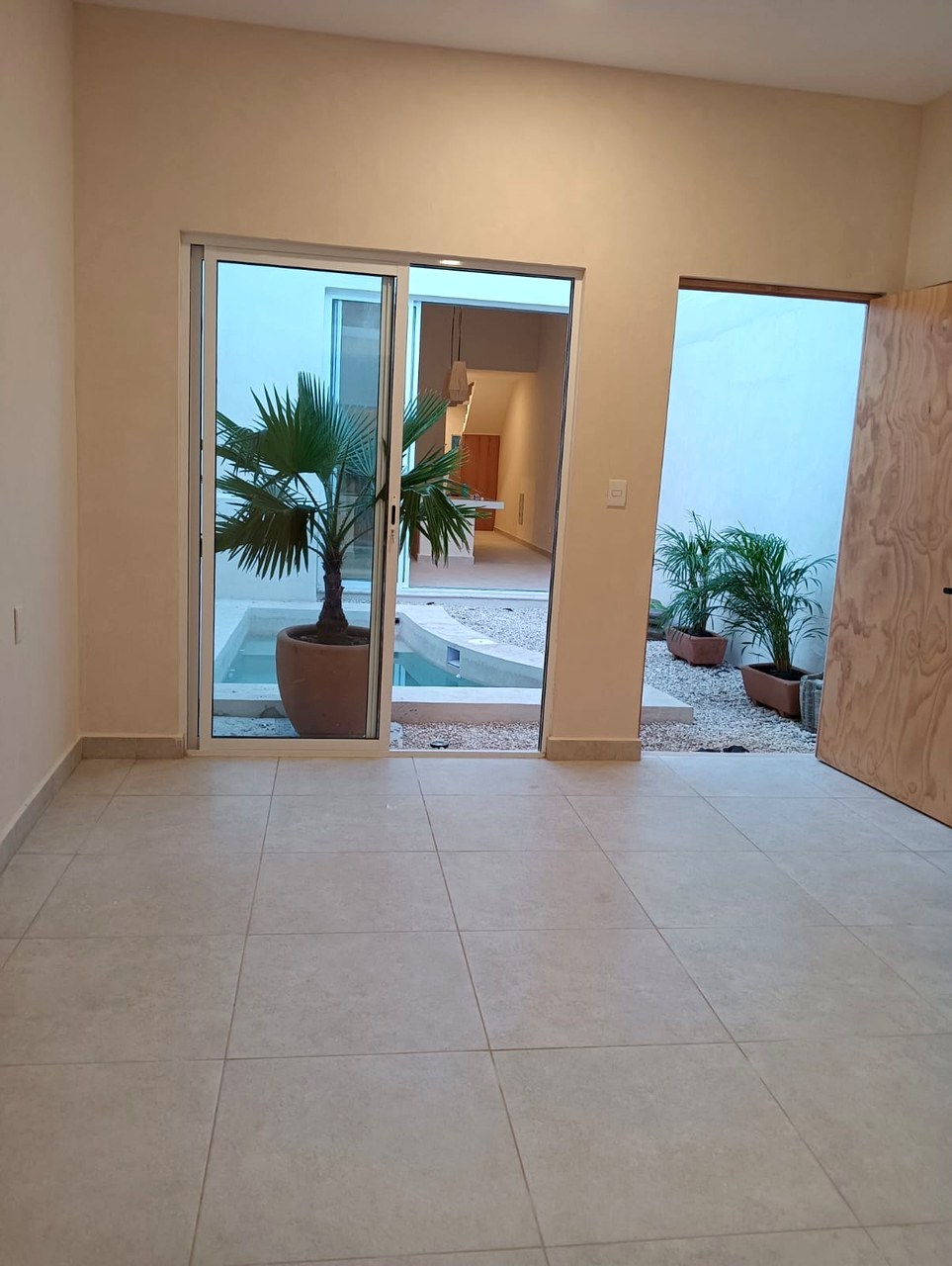 Casa Suspiro — interior view looking out to courtyard with tropical plants