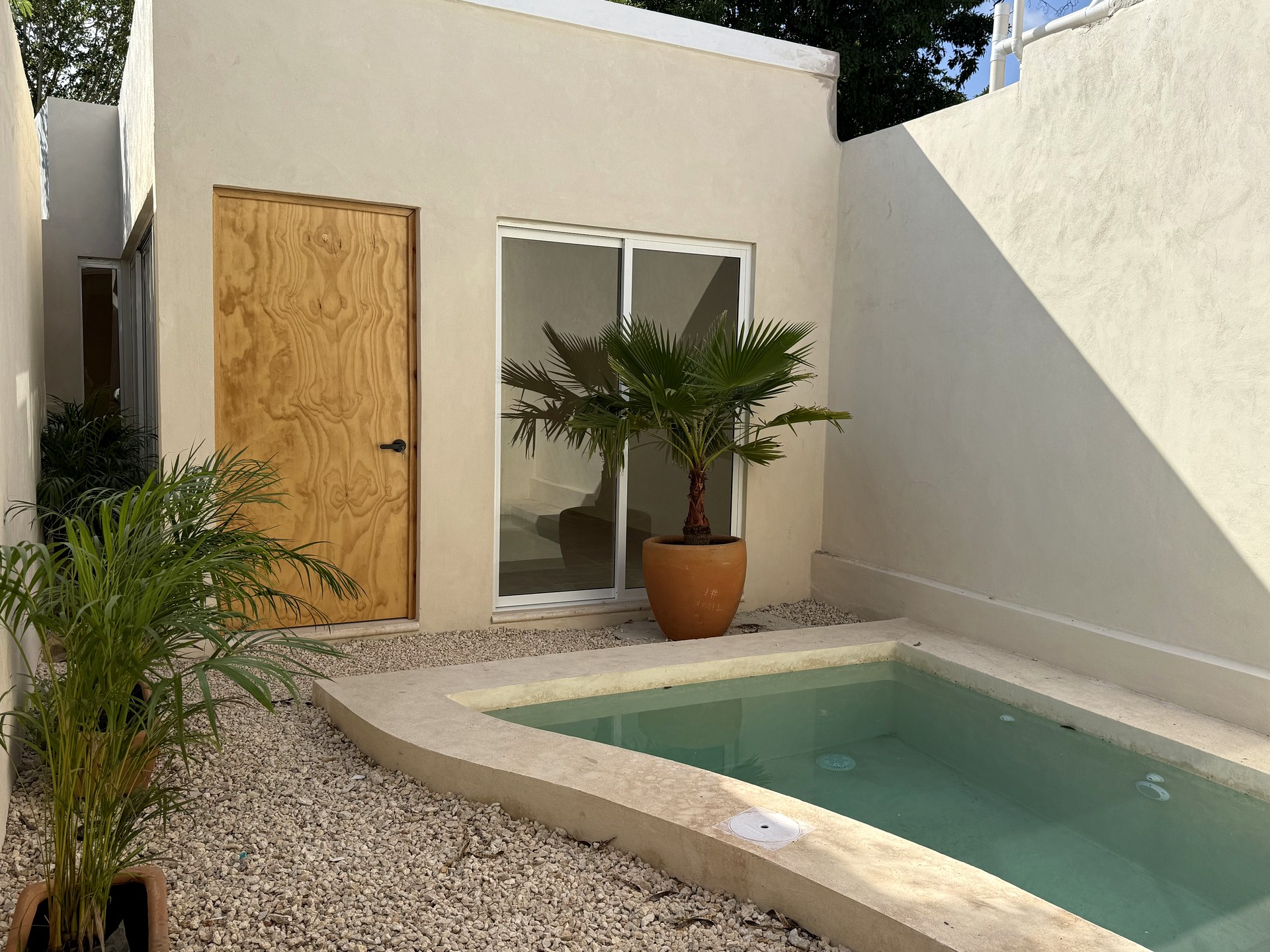 Casa Suspiro — pool detail with natural stone edge and tropical plants